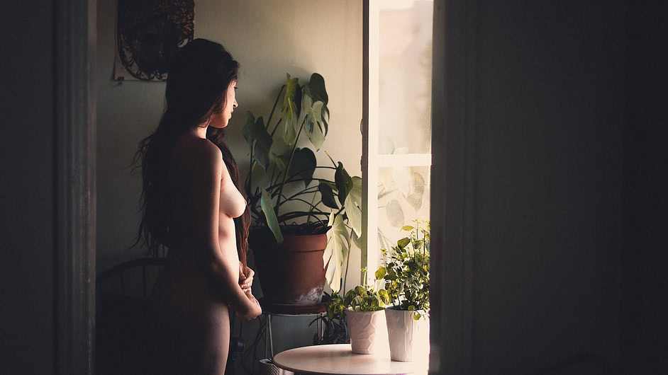 catalina standing naked by the kitchen window