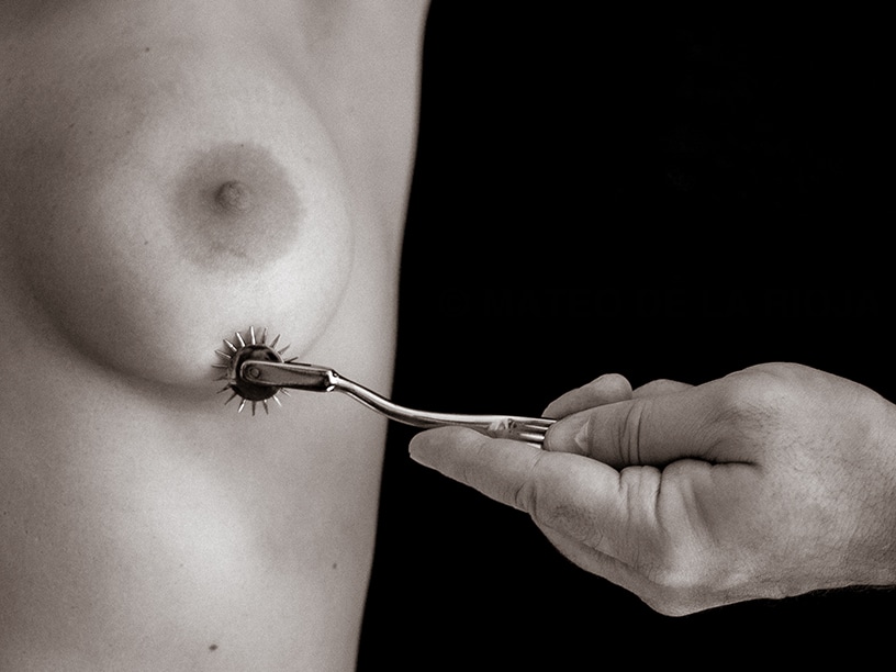 he inflects pain on her breasts by rolling a wartenberg wheel below her nipple