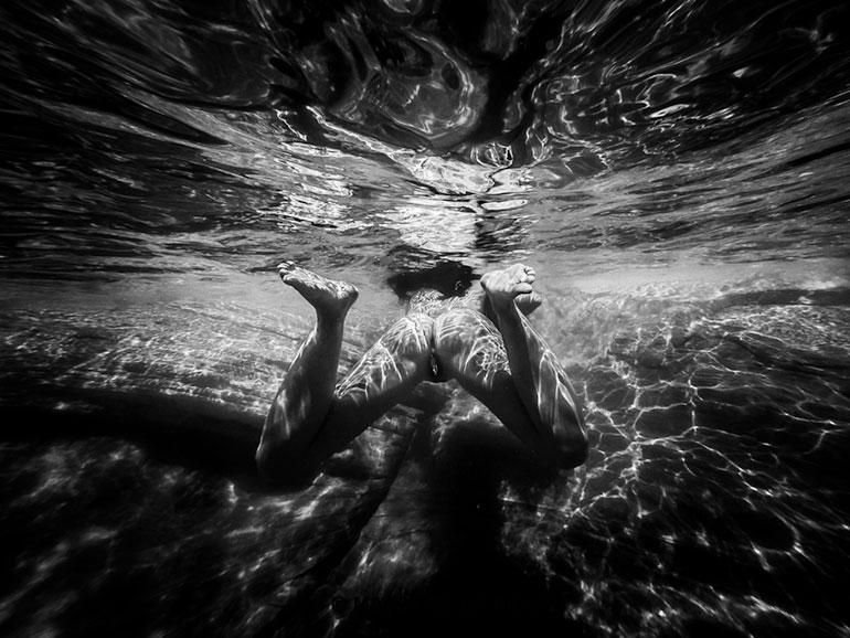 Underwater view of nude woman exposing her vagina swimming in a lake